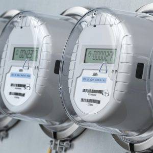 Digital electric meters in a row measuring power use. Electricity consumption concept.