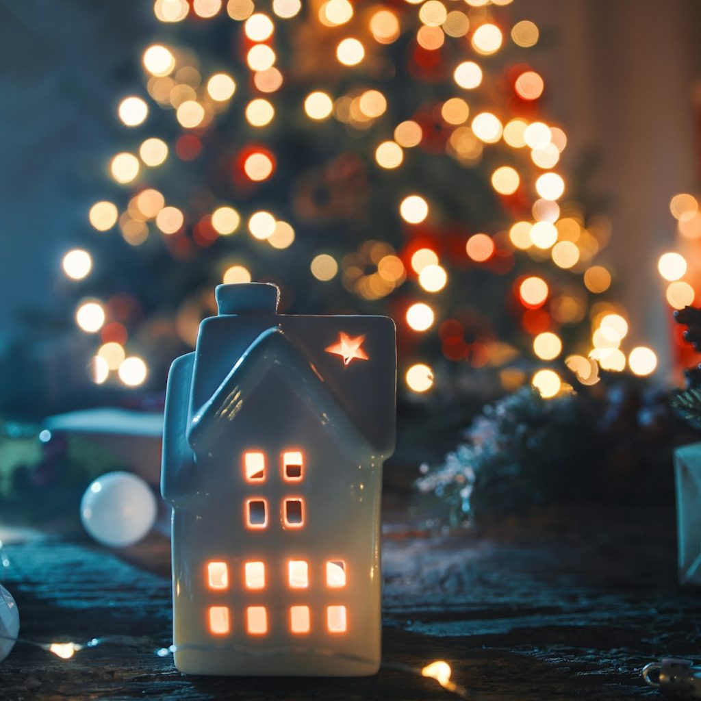 The little house with candle and tree as background
